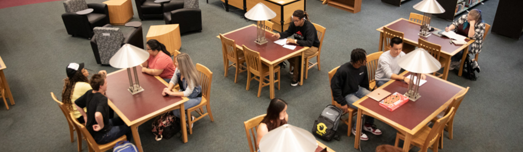 Students sitting at tables in library