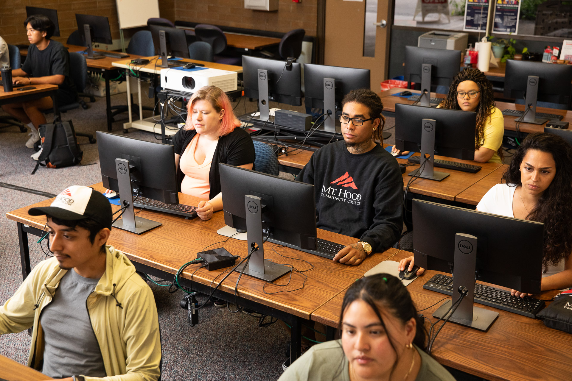 students sitting at computers in classroom