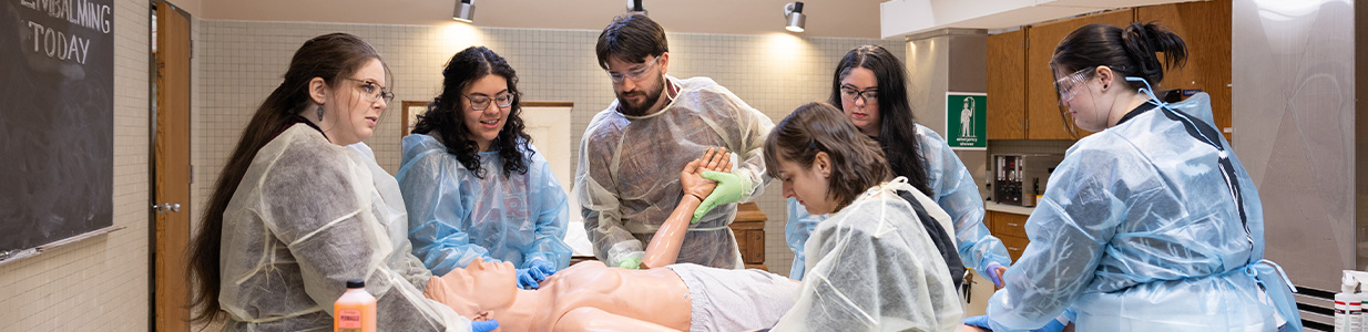 funeral service students working on a dummy