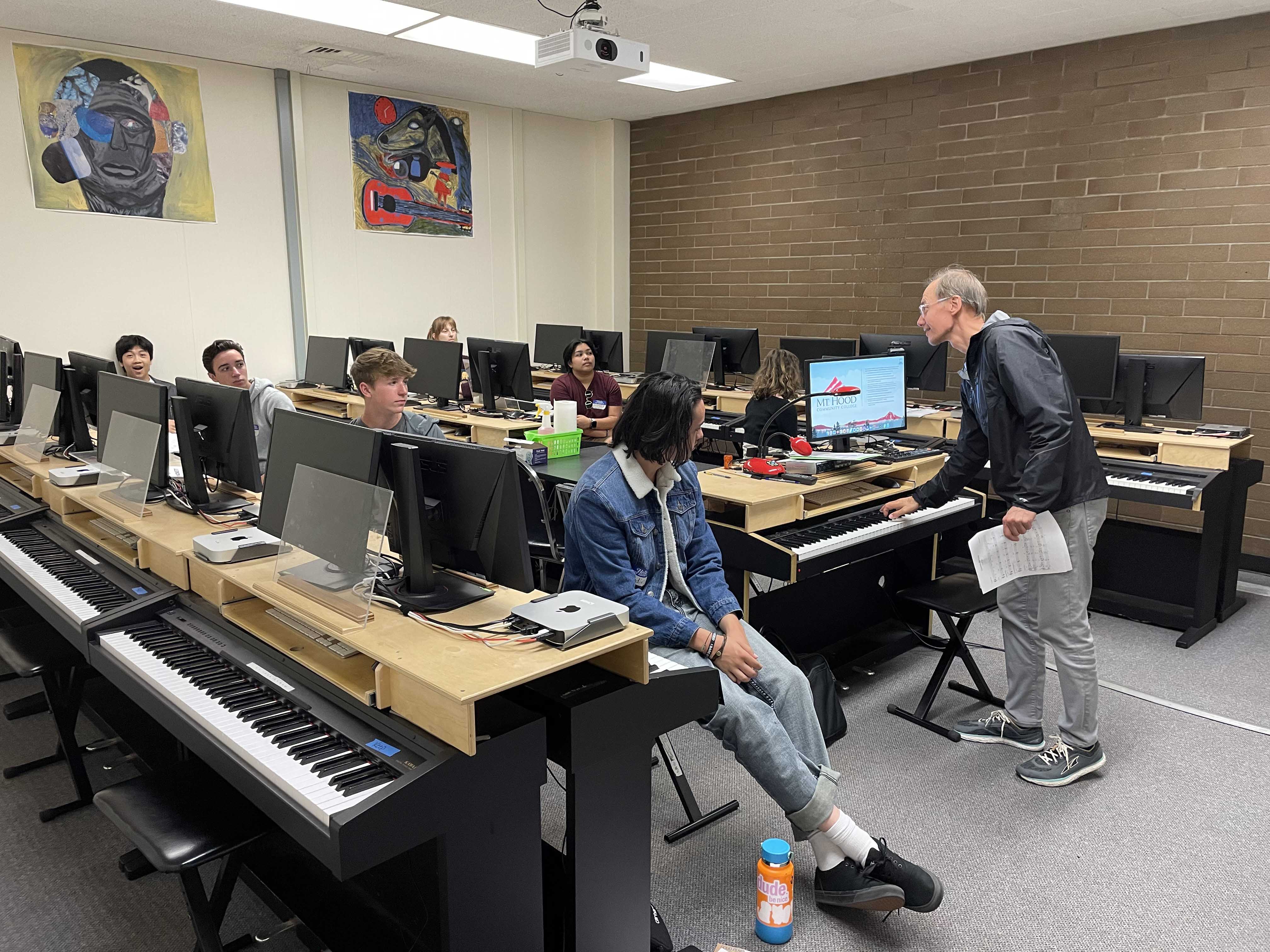 Instructor in the piano room with students