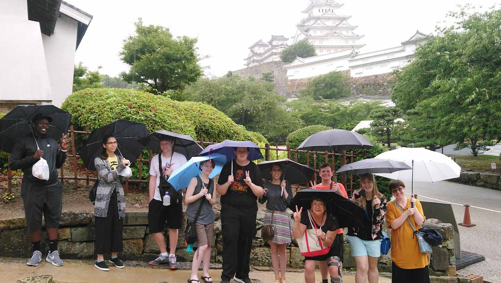 Students in the rain with umbrellas