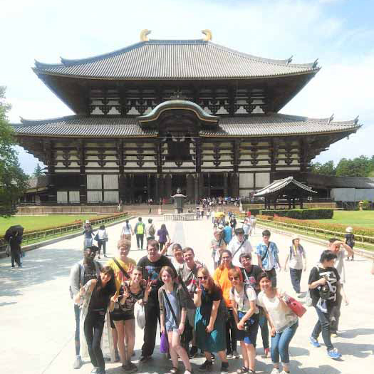 Students in Japan in front of a historic building